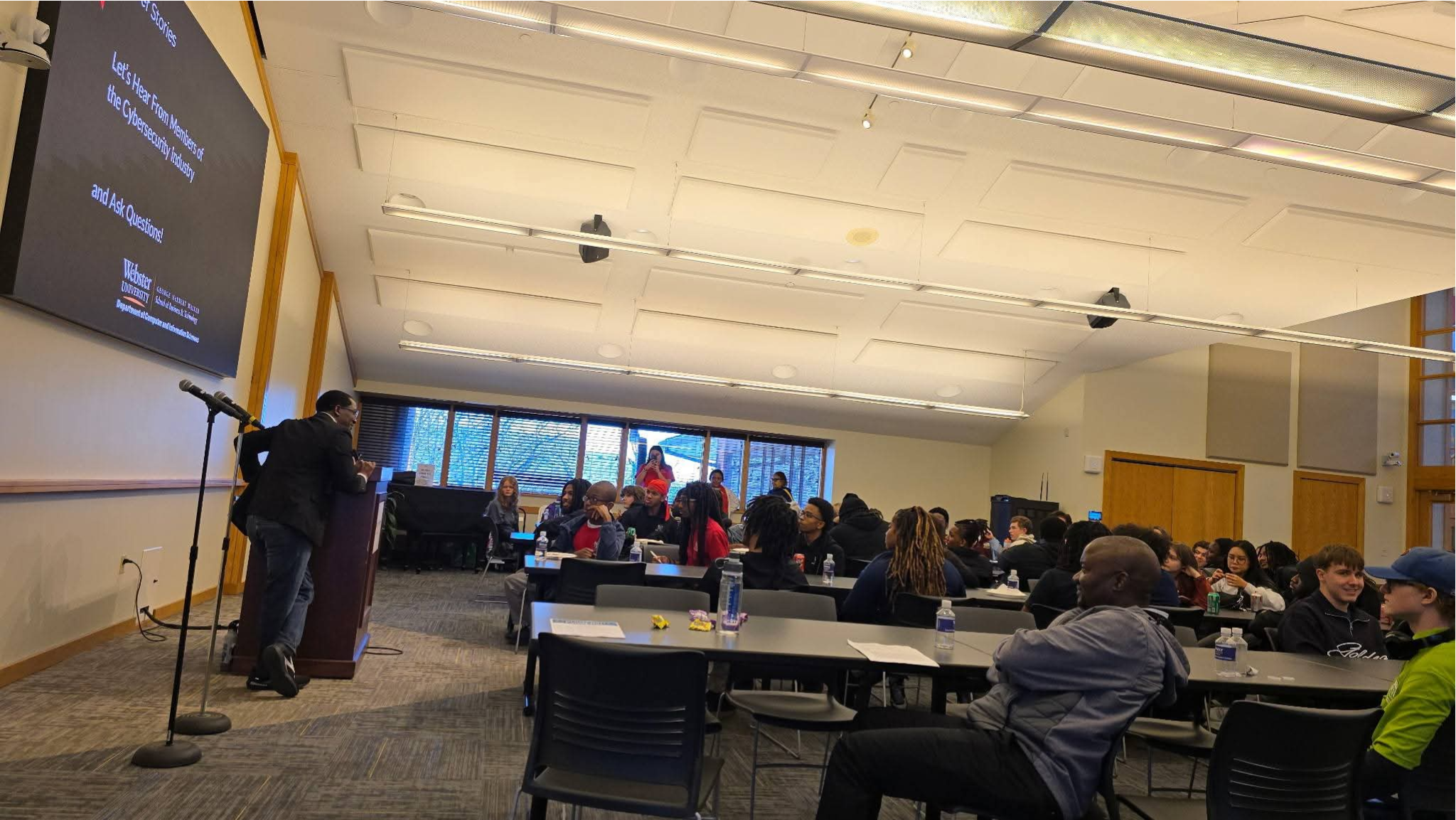 Adewale Ashogbon speaking to a cybersecurity audience at Webster University
