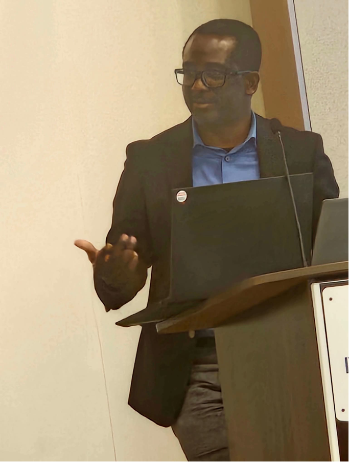 Adewale Ashogbon presenting from a podium